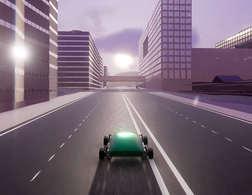 A small green car drives down a wide, empty city street under a cloudy sky, surrounded by tall, modern buildings with sunlight reflecting off the windows.